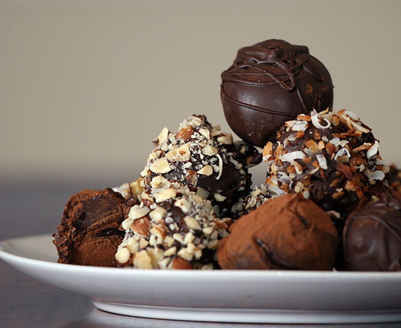 Plate piled high with chocolate truffles of all kinds