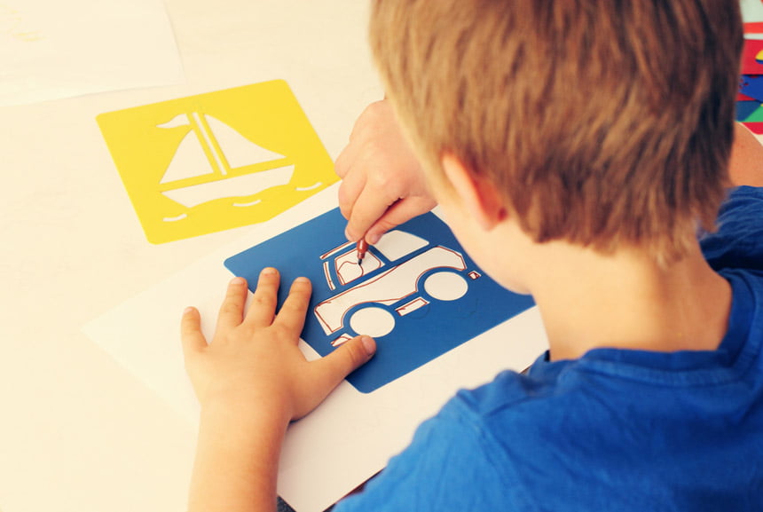 Picture of child tracing a car using a stencil