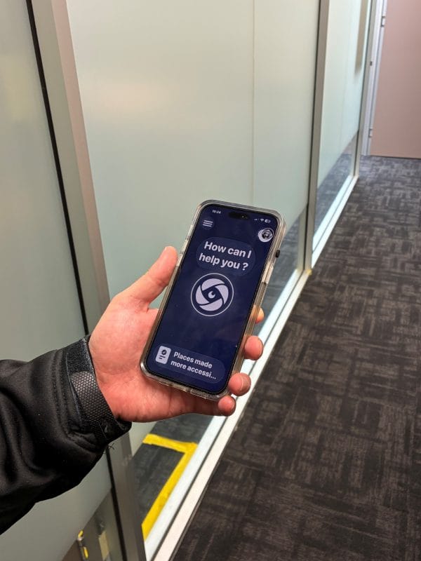 A phone being held in hand and displaying a form of assistive technology
